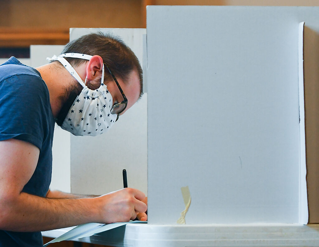 John Fifield fills out a ballot